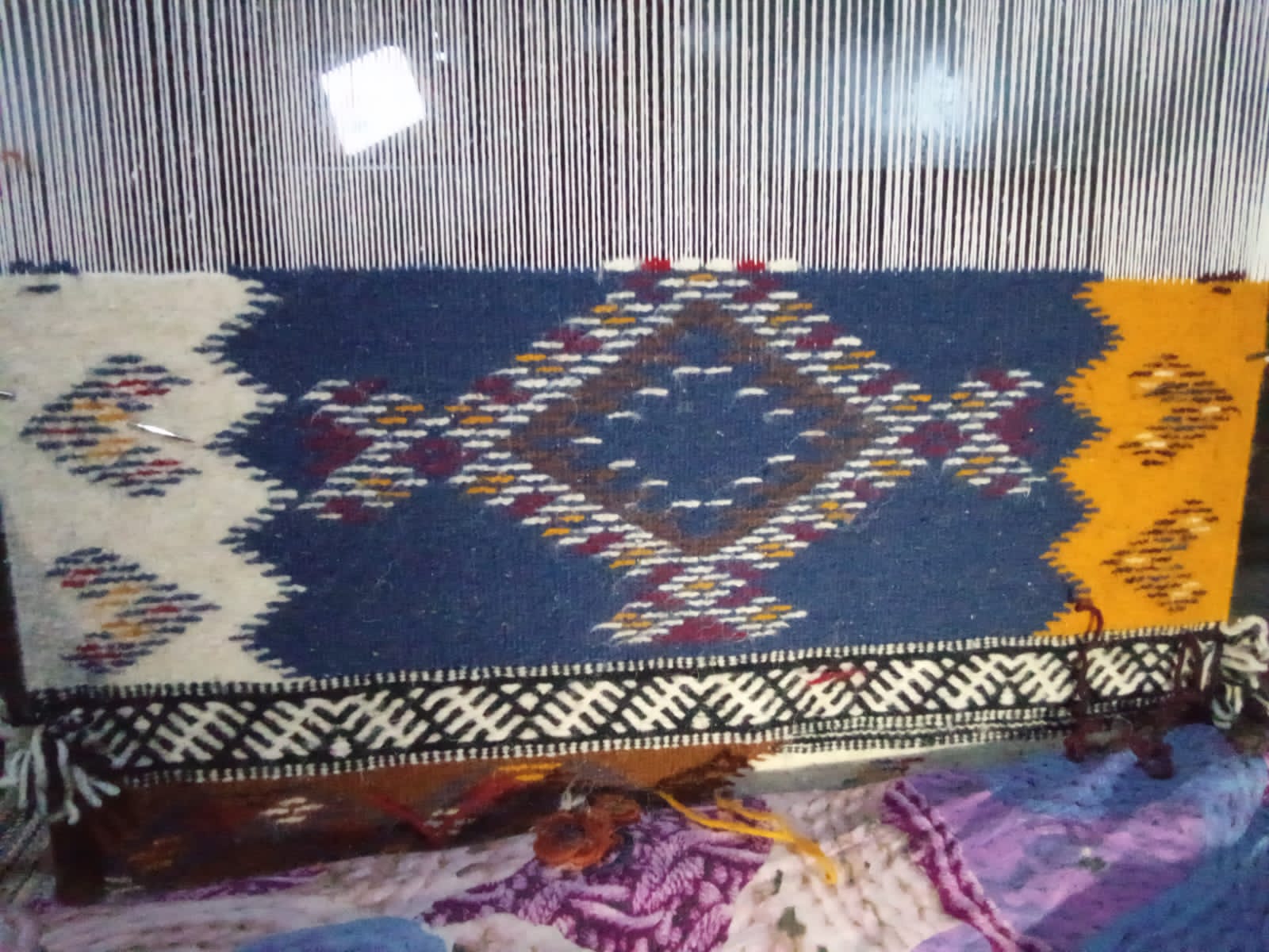 Tapis berbère tissé main motifs géométriques bleu et jaune